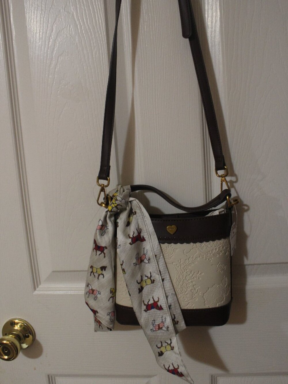 Title: Betsey Johnson Cream & Brown Embossed Skull Bucket Bag with Horse Scarf